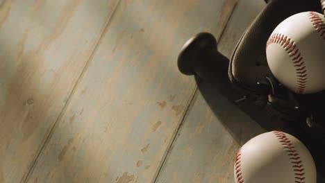 Close-Up-Studio-Baseball-Still-Life-With-Bat-Ball-And-Catchers-Mitt-On-Aged-Wooden-Floor-1
